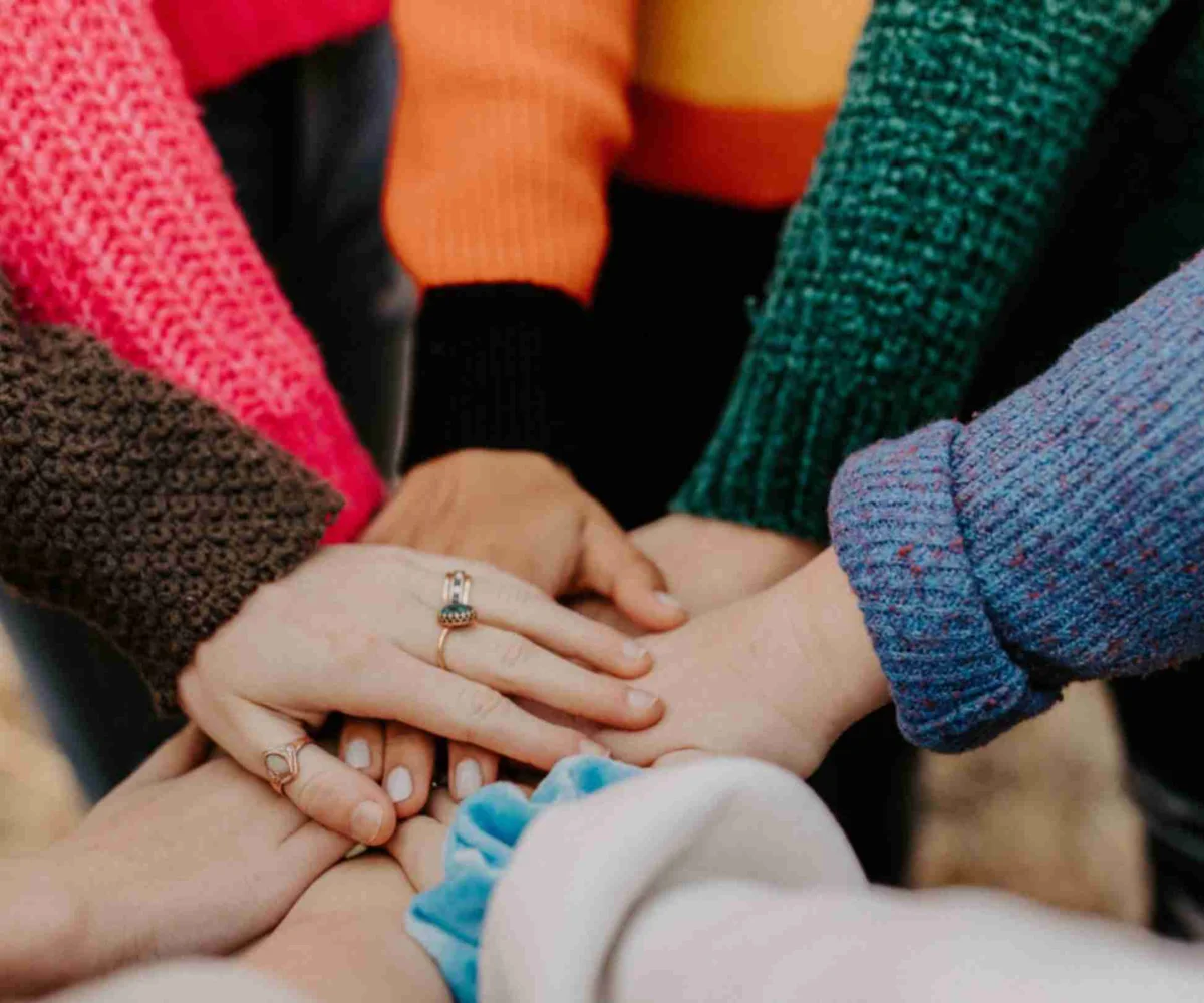 Close Up Of Eight Hands In On Top Of Eachother