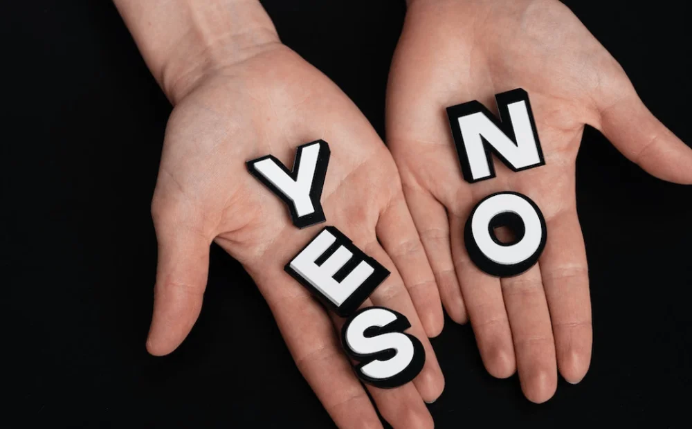 hands holding 'yes' and 'no' letters hands holding 'yes' and 'no' letters